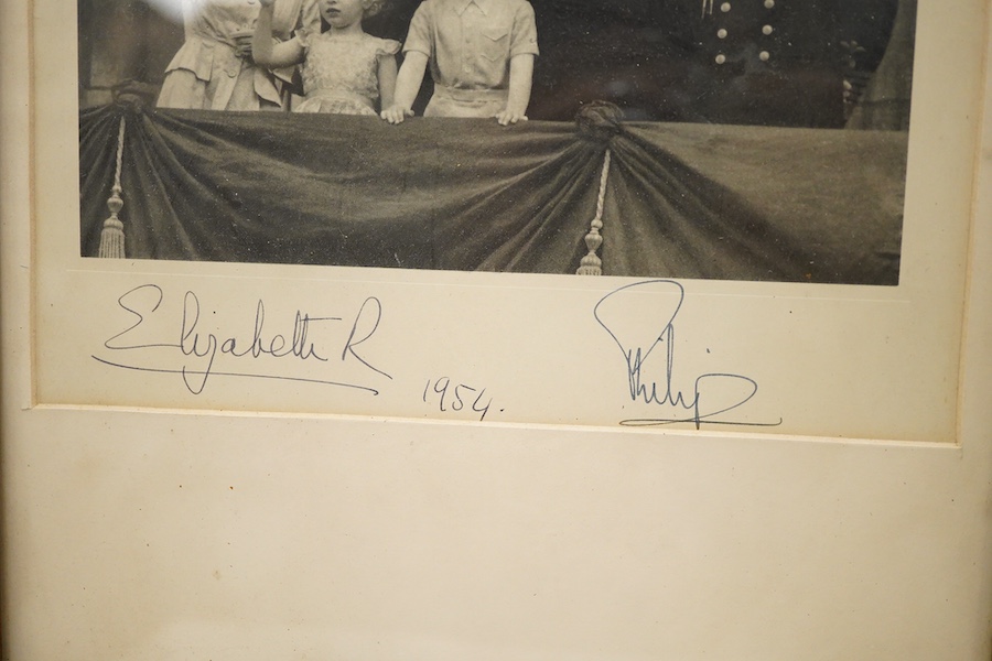 A framed photograph of Queen Elizabeth II, Prince Philip, King Charles and Princess Anne, signed by both the Queen and Prince Philip in ink, with each signature under their relevant image and dated 1954, contained within